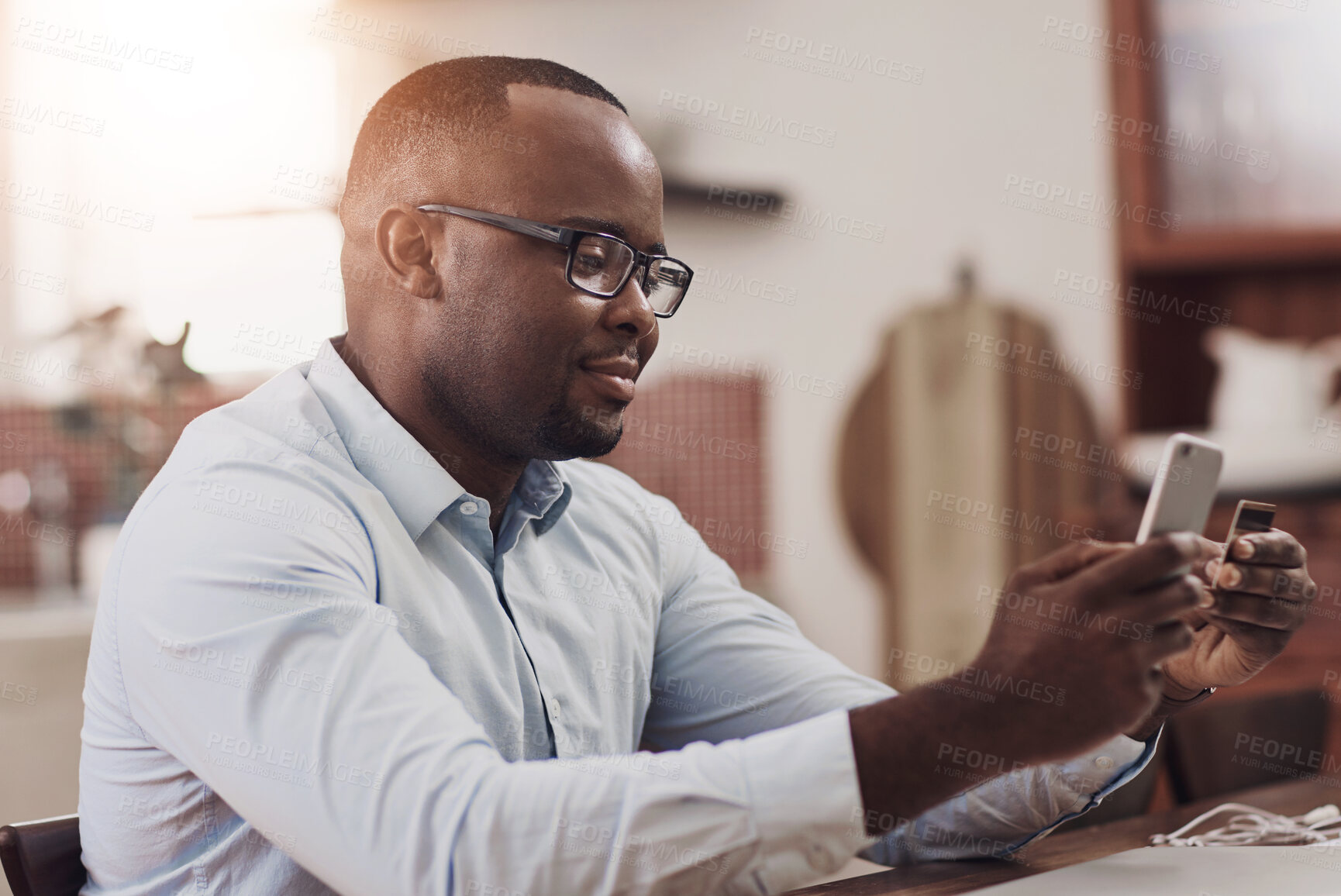 Buy stock photo Credit card, phone and black man in home for online payment of mortgage loan and utility bills. Cellphone, financial budget and African male person with internet banking app for savings account.