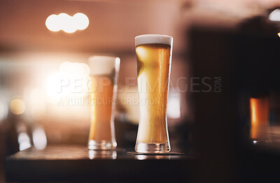 Buy stock photo Glasses, foam and cold beer in pub for drinks as draft from pint with craft, fresh or smooth taste. Weizen, bubbles and golden, alcohol and lager from brewery in restaurant for celebration in Germany