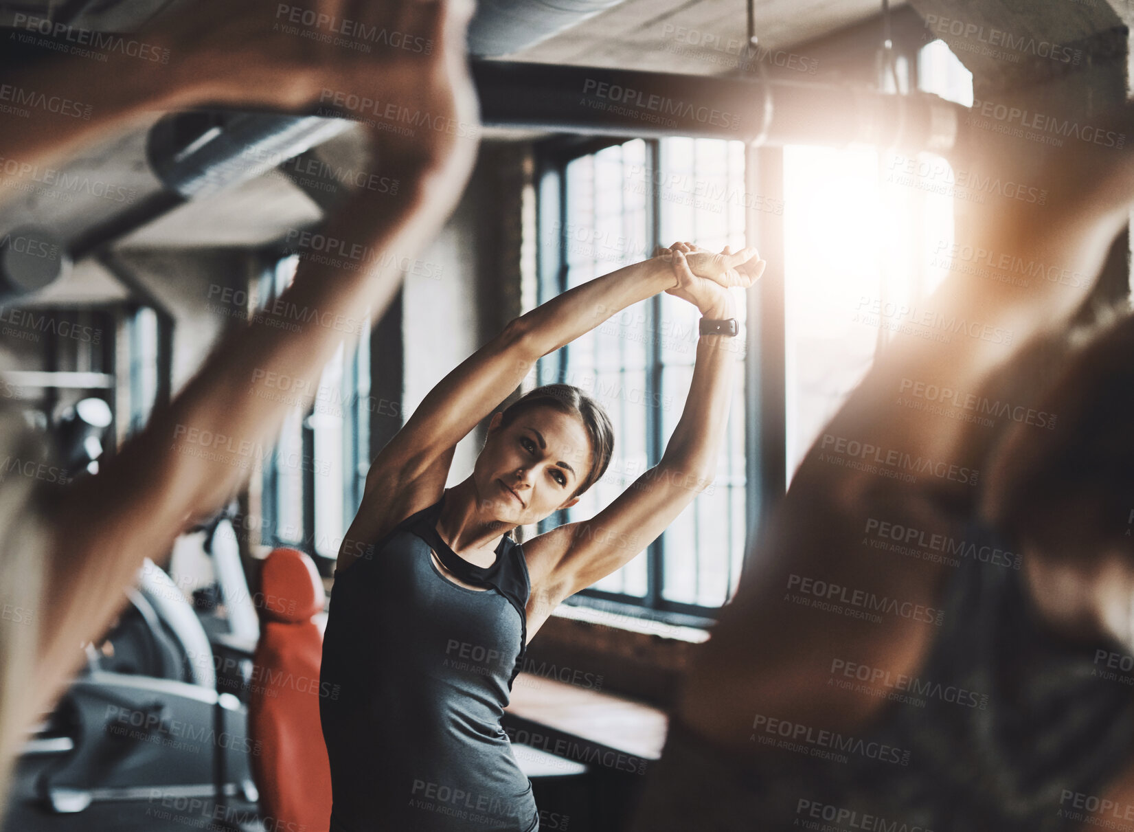 Buy stock photo Instructor, group and stretching in gym for fitness with arm exercise, muscle workout and strength training challenge. Personal trainer, people or warm up for healthy body, performance or competition