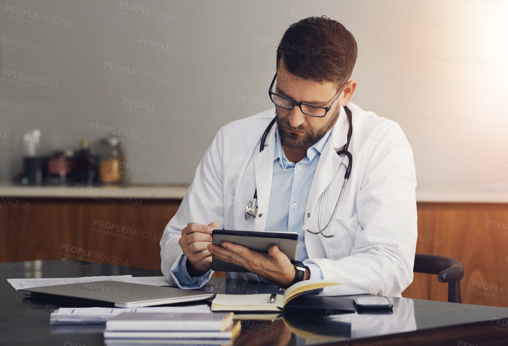 Buy stock photo Medical, doctor and man with tablet, typing and research for diagnosis, healthcare and online reading for cancer article. Person, physician or professional with tech, digital app for schedule or text