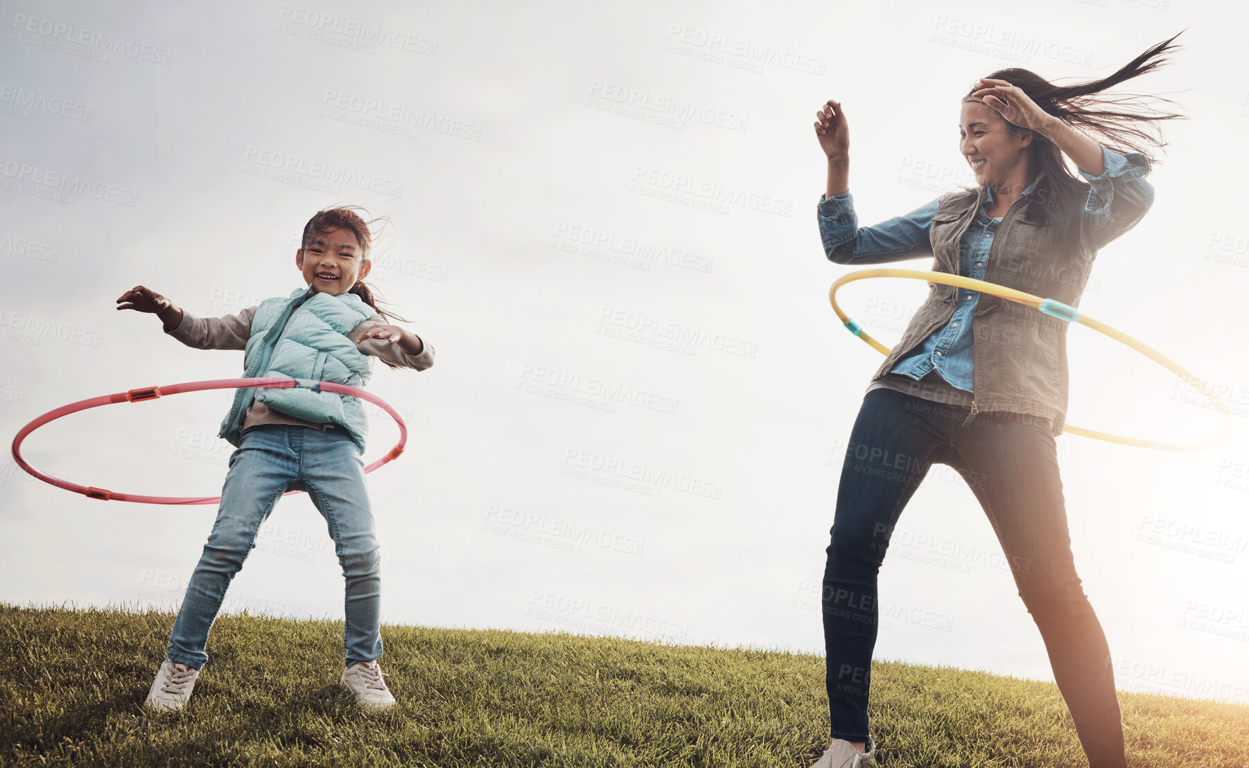 Buy stock photo Mother, child and dance with hoop in field, play and nature in autumn for activity. Daughter, together and bonding with female person or mom with girl, outdoor and smile for holiday in park with toys