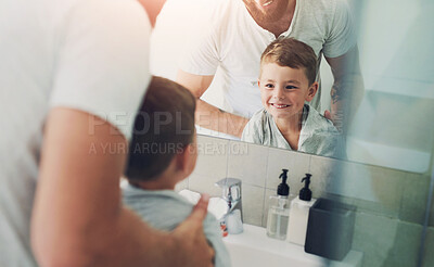 Buy stock photo Boy, child and father by mirror in bathroom with smile, cleaning and hygiene with helping hand in home. Dad, kid and happy for wellness in routine, grooming or start morning with care in family house