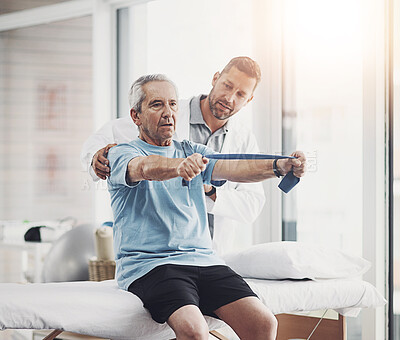 Buy stock photo Senior man, physiotherapist and band for resistance training, muscle healing or healthcare clinic. Fitness, physiotherapy and elderly person on bed for mobility exercise, rehabilitation or retirement