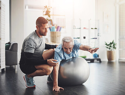 Buy stock photo Stretching, elderly man and physiotherapist with ball for mobility training, support or muscle workout. Fitness, physiotherapy and senior person with exercise, development or healthcare in retirement