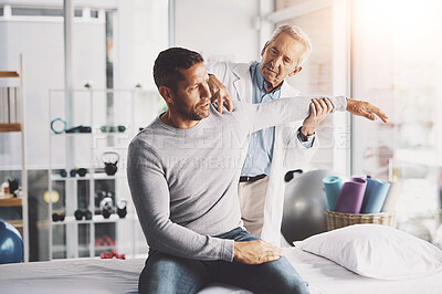 Buy stock photo Medical, doctor and stretching with patient for shoulder pain with physical therapy, examination or body recovery. Orthopedic, man physician or health expert for arm rehab with consultation or advice