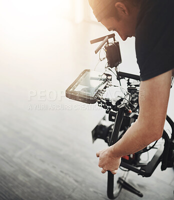 Buy stock photo Man, videographer and camera with stand on floor for filmmaking, cinema or online vlog at studio. Young male person or producer with photography tools or equipment for production or recording at set