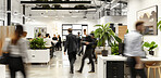 Busy, workspace and business people walk in office, company or work startup with computer on desk. Blur, motion and group in coworking space for rush, workflow or employees moving fast with plants