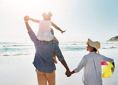 Buy stock photo Family, child and parents piggyback on beach for holiday, vacation and travel with support, love and freedom. Back of kid with dad, mom or people bonding together, walking and adventure games by sea