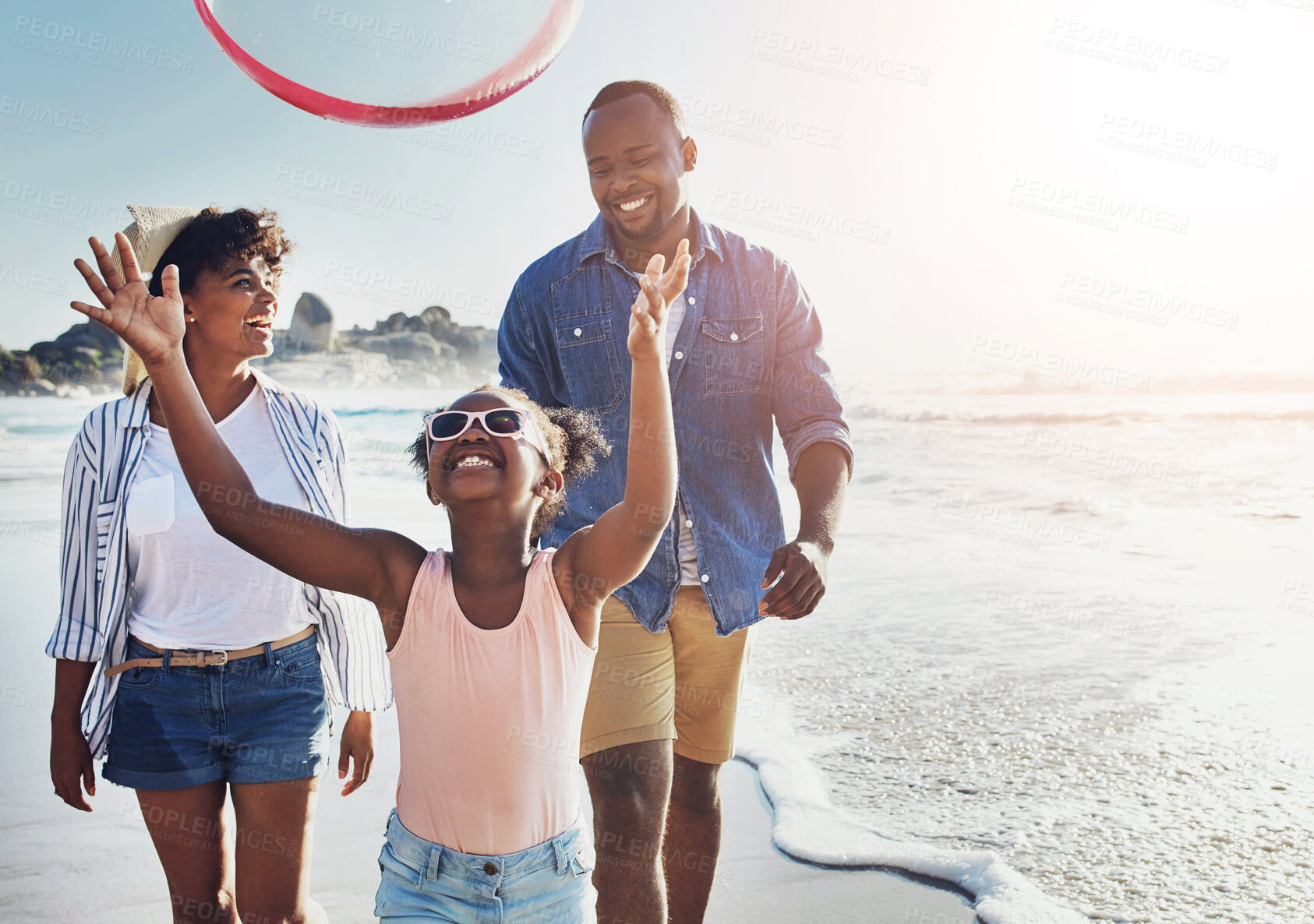 Buy stock photo Happy, hoop and family by beach on vacation, adventure or holiday for bonding in summer. Fun, smile and African girl child with parents playing with plastic ring toy by ocean on weekend trip.