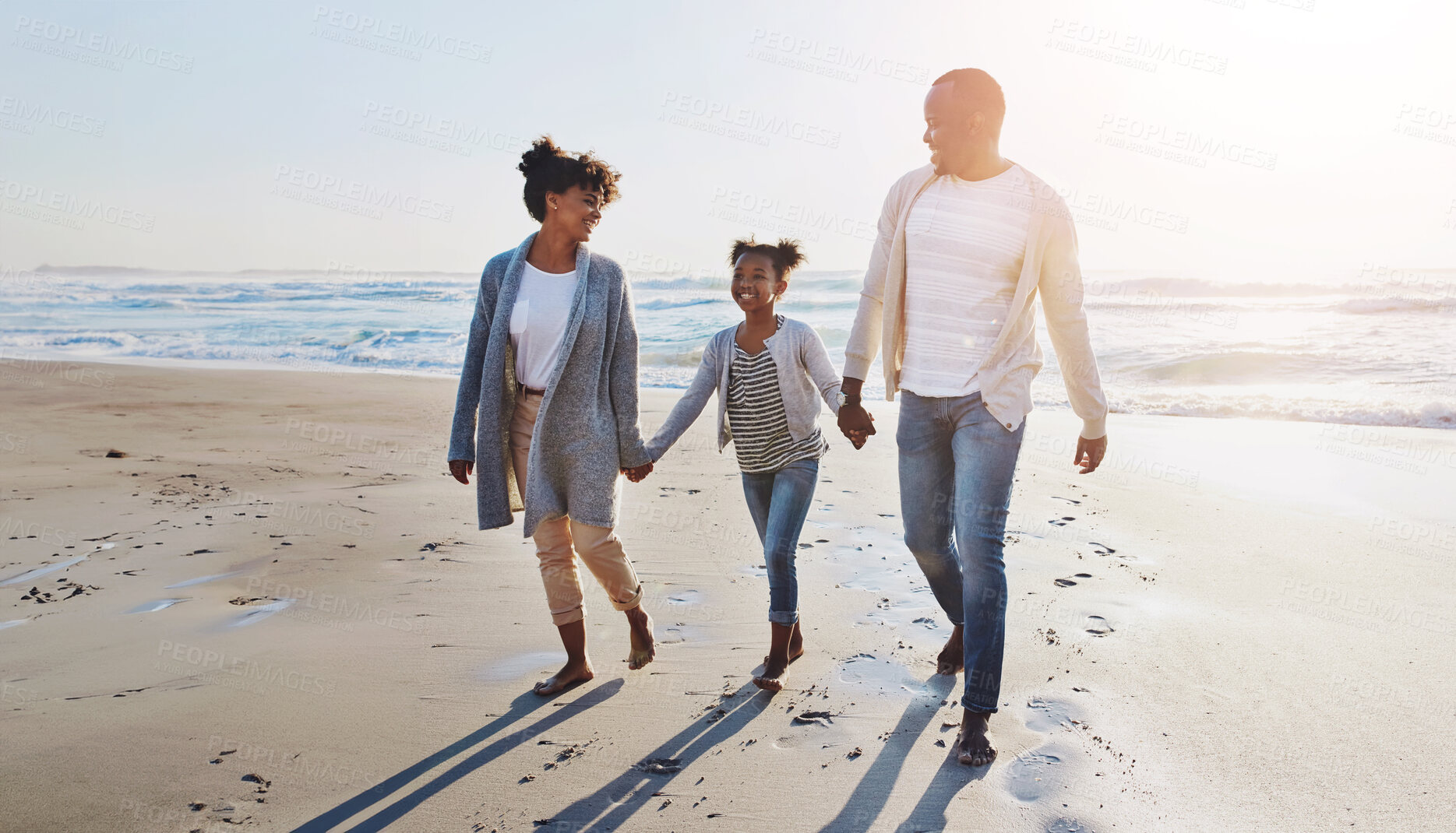 Buy stock photo Black family, happy and holding hands for walking on beach with travel memory, vacation or summer holiday. Parents, kid or bonding in nature with fun activity, scenery and smile for sunset adventure
