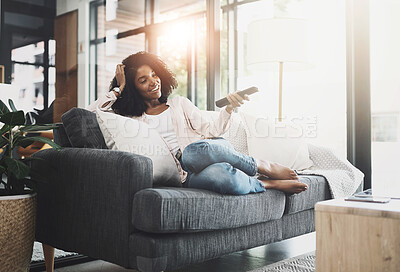 Buy stock photo Relax, remote and smile with woman watching tv on sofa in living room of home for break or time off. Comfortable, streaming video and happy person in apartment with subscription service television
