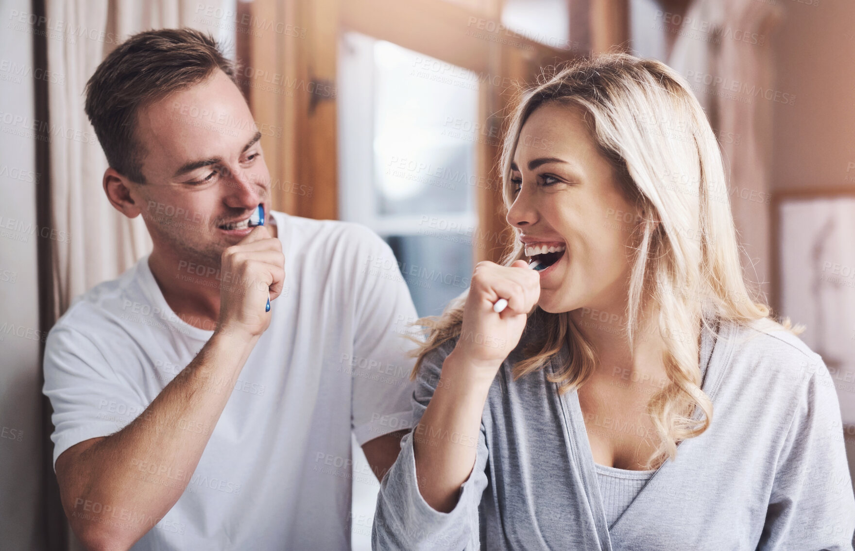 Buy stock photo Dental, toothbrush and couple brushing teeth in bathroom  with smile for oral hygiene, fresh breath or morning routine. Home, wellness and happy woman with man for whitening, cleaning or mouth care