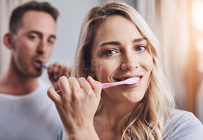 Buy stock photo Portrait, dental and woman brushing teeth with man in bathroom for oral hygiene, fresh breath or morning routine. Smile, wellness and couple with toothbrush for whitening, cleaning or mouth care
