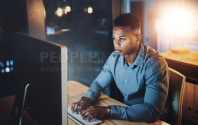 Buy stock photo Dark, office and black man at computer typing, online research or web programmer at tech startup. Night, planning and network developer writing email, coding or business report at digital agency.