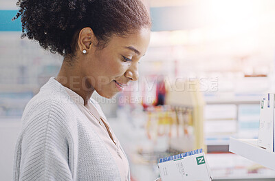Buy stock photo Happy, black woman and customer with box at pharmacy for side effects, symptoms or medical care at pharmaceutical store. Young African, female person or shopper reading product on healthcare benefits