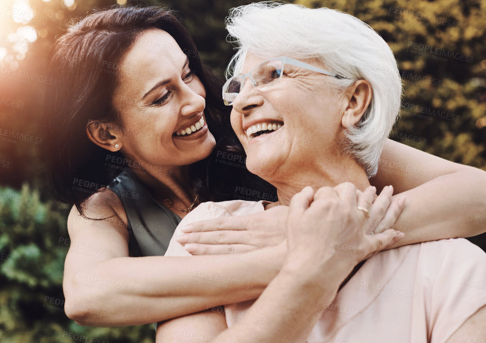 Buy stock photo Outdoor, senior mother and woman with hug for love, vacation and bonding together in garden. Happy people, mom and daughter with embrace in park, care and healthy relationship in nature with flare