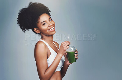 Buy stock photo Green, juice and woman in portrait by studio for health, nutrition and detox with wellness diet for drinking. Black girl, beverage and organic shake with vitamins and mockup space by gray background