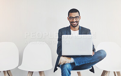 Buy stock photo Waiting room, business man and laptop for recruitment, planning and research questions for hr interview. Wall background, male candidate and digital for information, opportunity and reading portfolio