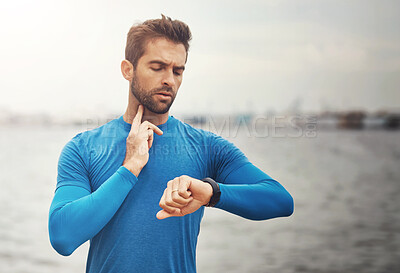 Buy stock photo Outdoor, running and man with heart rate on smart watch for exercise, wellness and digital health stats at ocean. Technology, morning workout and runner with wristwatch to check pulse on fitness app