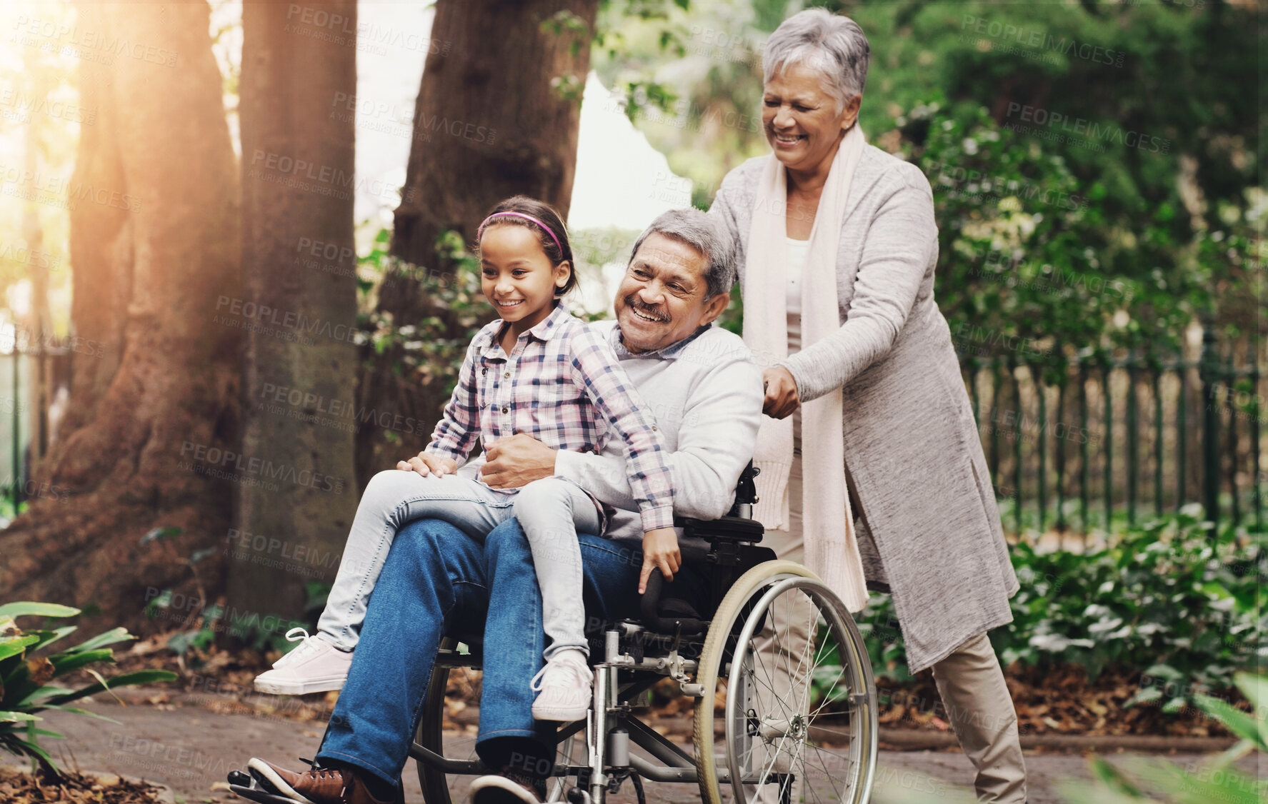 Buy stock photo Grandparents, child and park with senior man in wheelchair for support, bonding and fun in morning travel. Smile, family and girl or grandfather with disability for security, trust and adventure