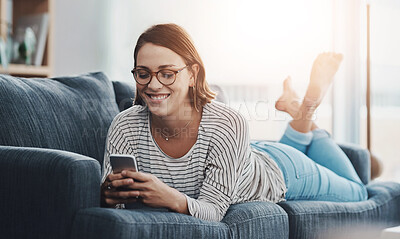 Buy stock photo Relax, smile and woman on sofa with phone for text, funny group chat and social media at home. Female person, mobile and happy on weekend for communication, ecommerce or sale on online shop in lounge