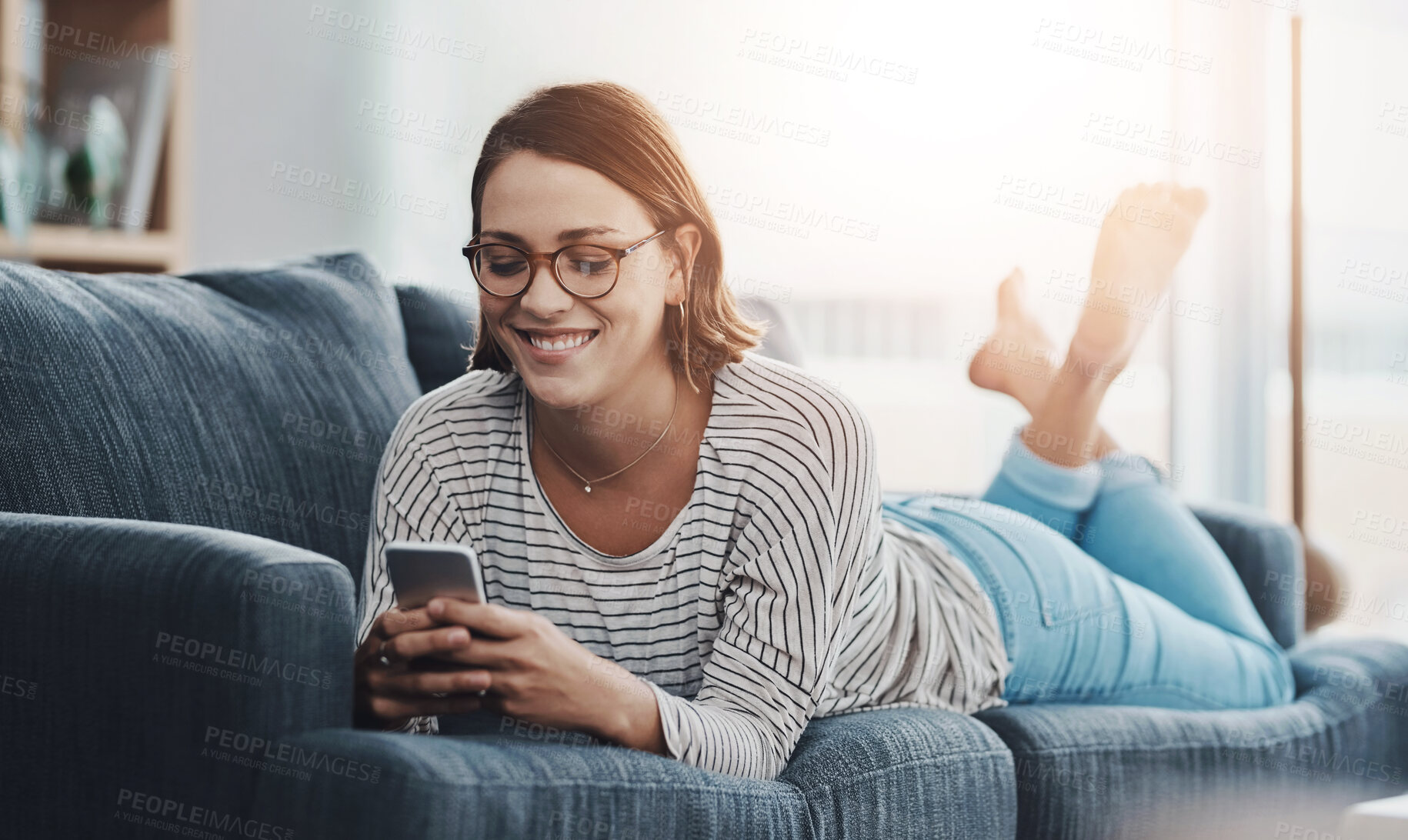 Buy stock photo Relax, smile and woman on sofa with phone for text, funny group chat and social media at home. Female person, mobile and happy on weekend for communication, ecommerce or sale on online shop in lounge