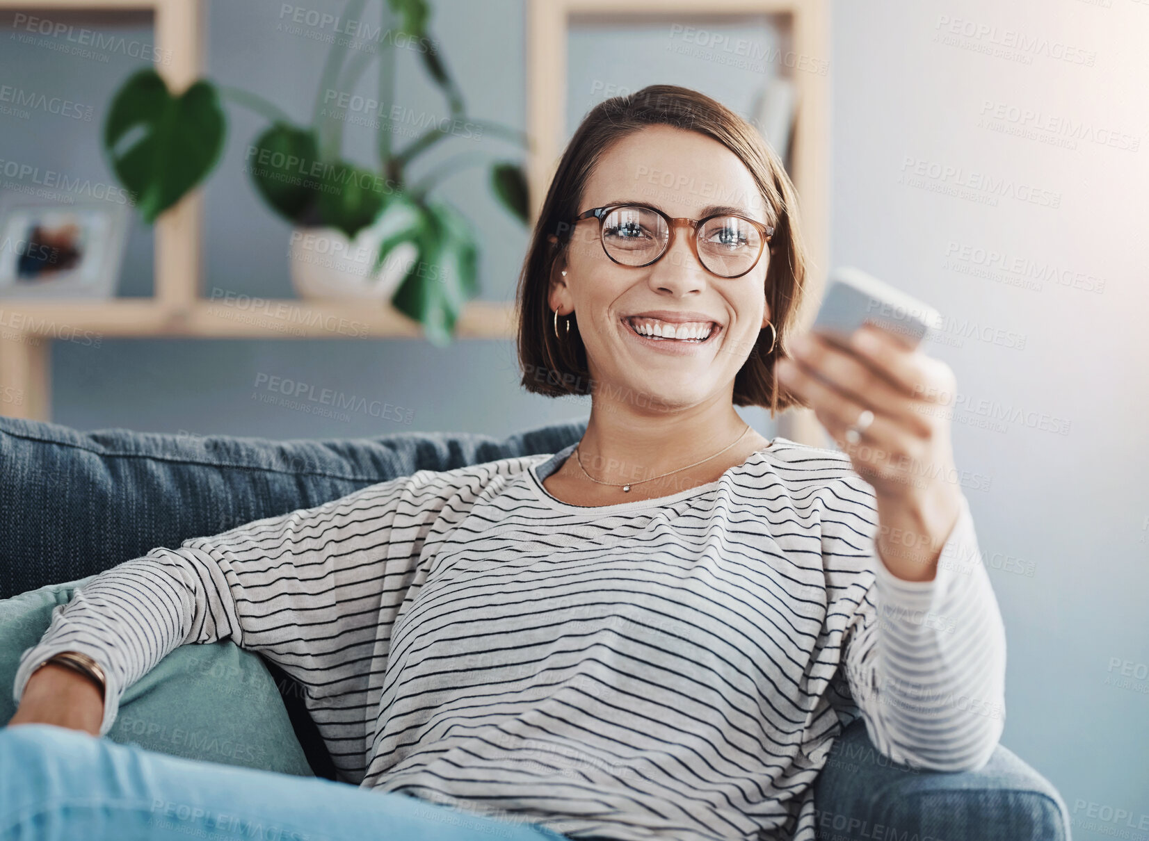 Buy stock photo Happy, woman and relax with remote control on sofa for streaming film, comedy show and subscription for series. Girl, couch and home for leisure on weekend afternoon, movies and chilling to unwind.