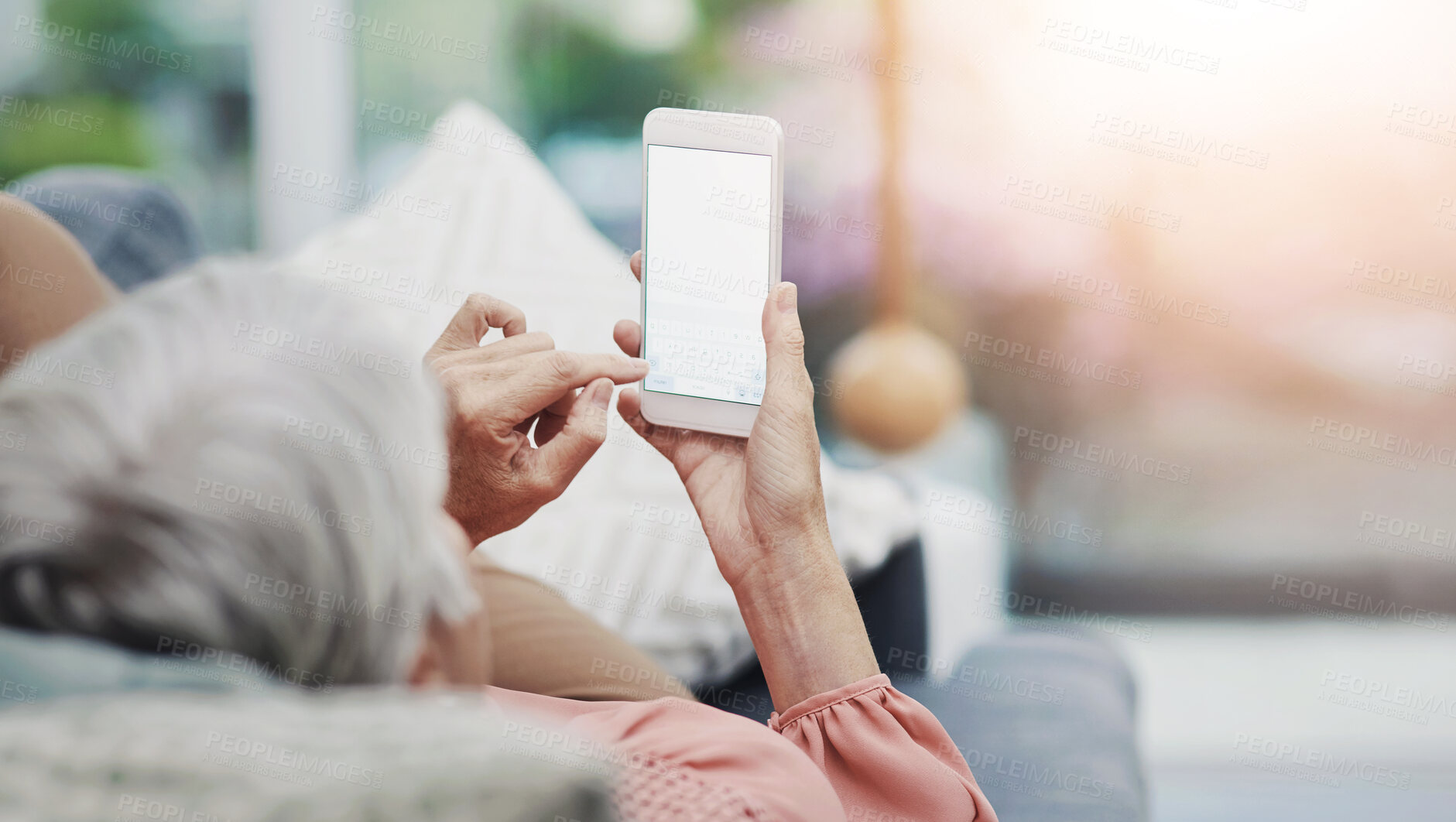 Buy stock photo Hands, cellphone and screen for typing, couch and senior woman in living room, mockup and texting. Display, digital and mobile for elderly person, relax and communication with contact in home