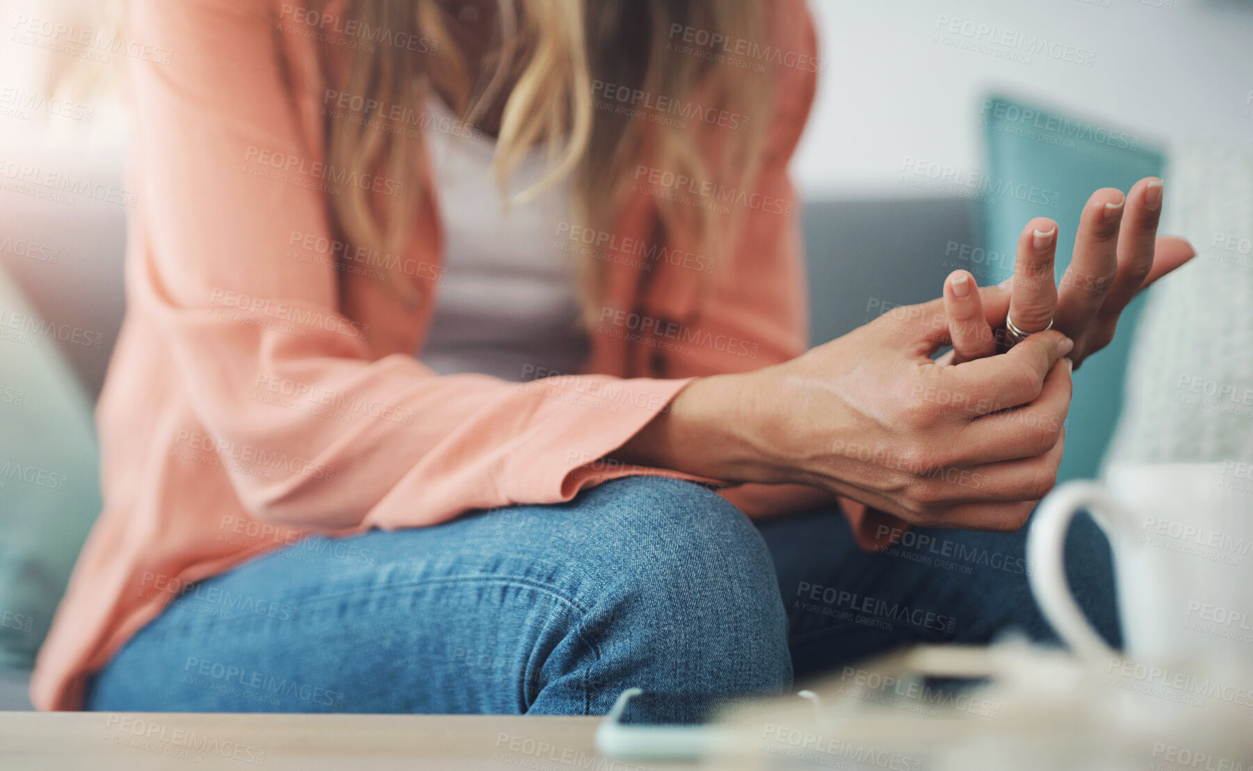 Buy stock photo Hands, woman and ring with doubt in marriage for toxic relationship, infidelity or divorce at home. Stress, decision or person on sofa with wedding band, conflict or unhappy for mistake or depression