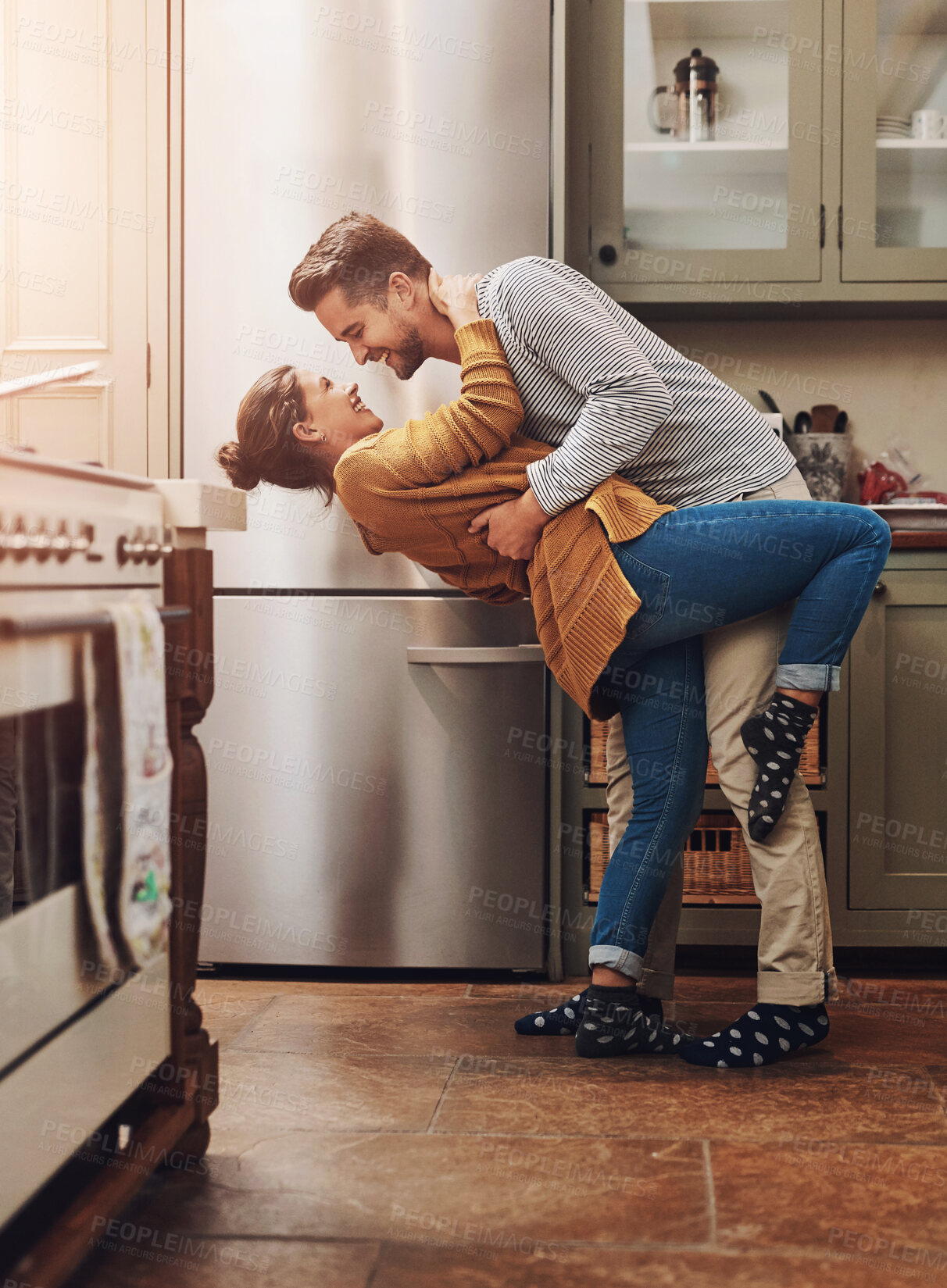 Buy stock photo Happy, couple and dancing with love in kitchen for bonding, romantic connection and sweet embrace for relationship. Man, woman and together in home with rhythm for affection, care and compassion.