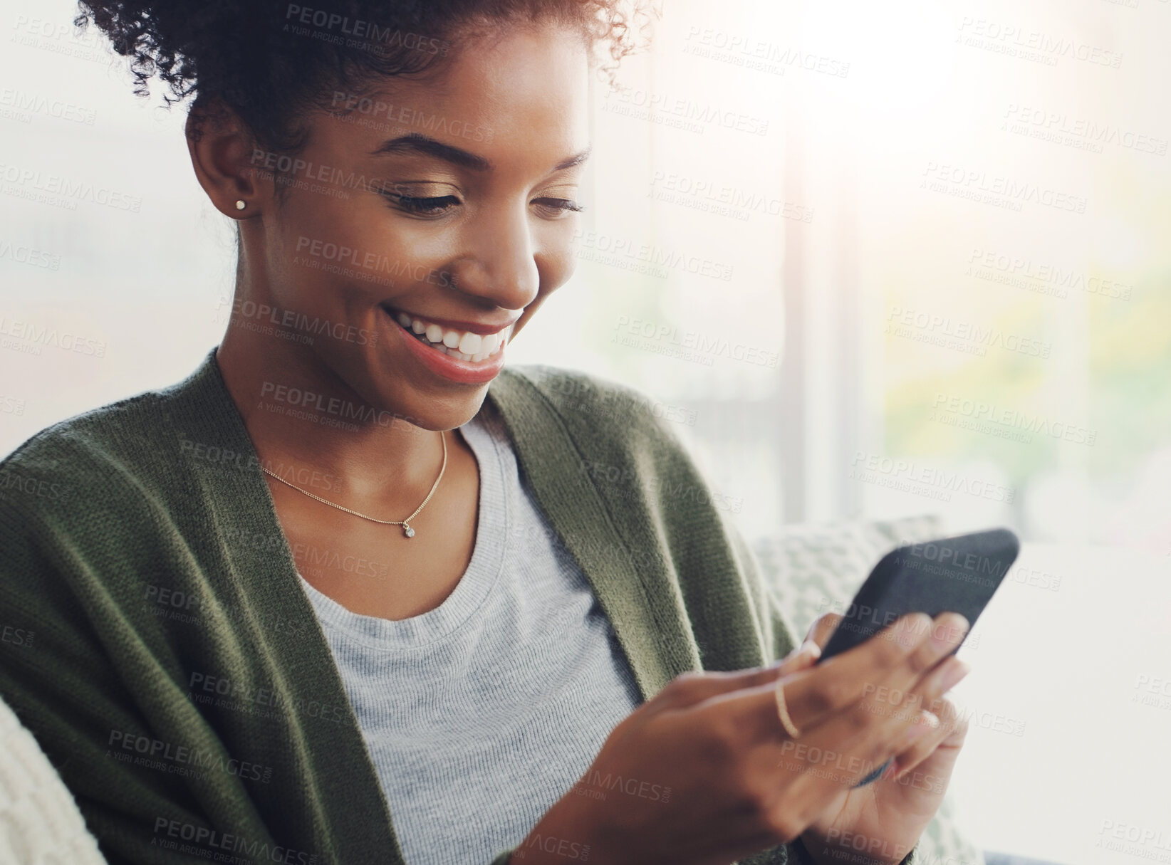 Buy stock photo Black woman, smartphone and cheerful in home for social media, application and connection with smile. Female person, technology and happy for good news, update or email in house on weekend or day off