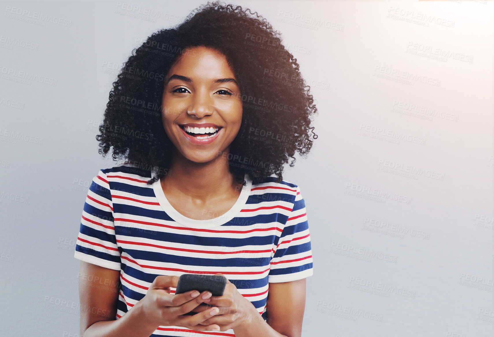 Buy stock photo Studio, portrait and African woman with smartphone for chat, laugh and online connection with contact. Female person, social media and cellphone with mobile app, gossip and mockup by gray background