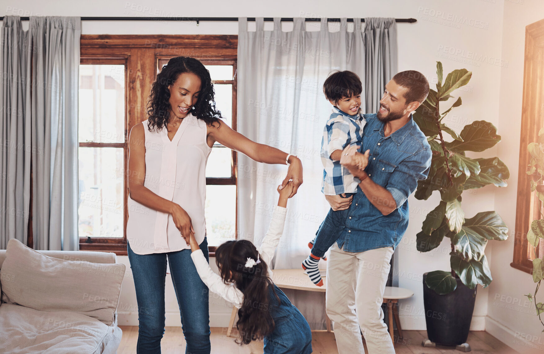 Buy stock photo Dance, happy family and music in home for love, support and birthday celebration in living room. Parents, kids and movement together for trust, relationship development and energy for weekend fun