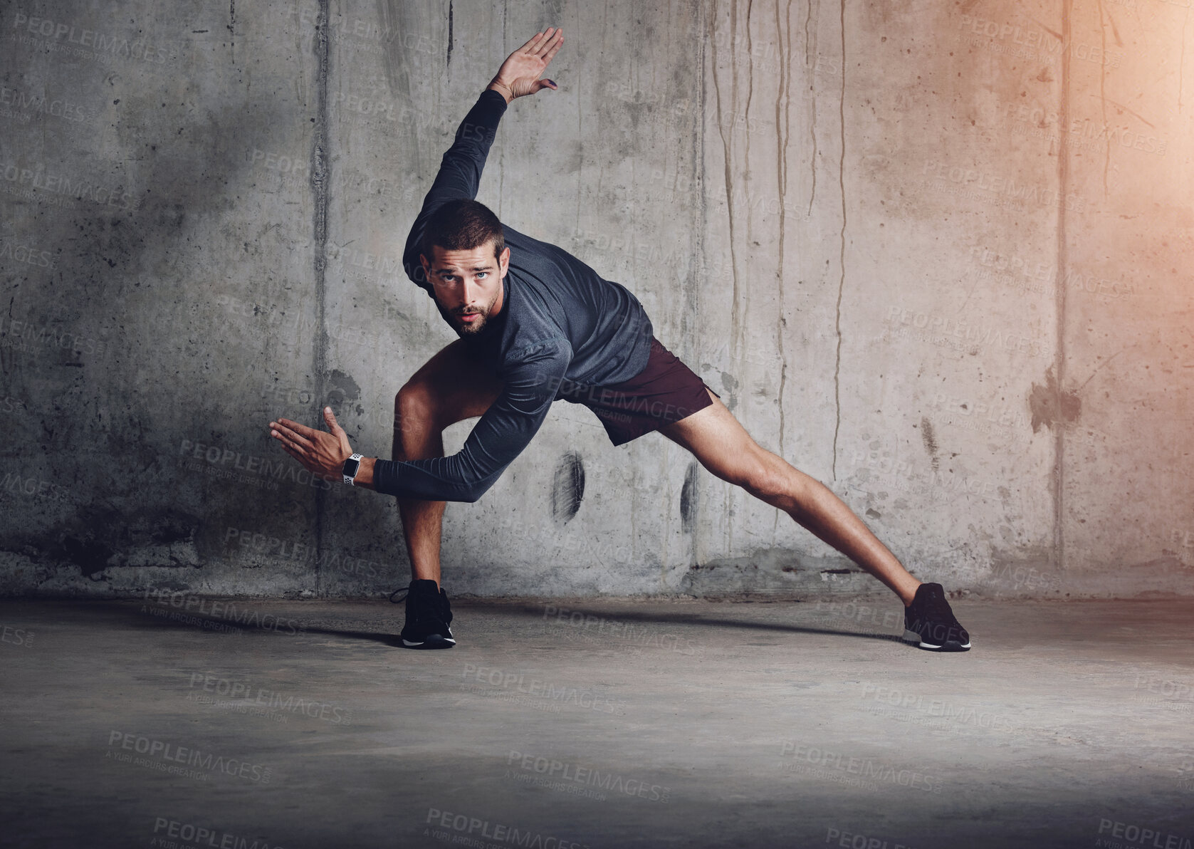 Buy stock photo Fitness, stretching and portrait of man at wall for sprint, intense exercise and commitment to sport. Male athlete, wellness and prepare for run for cardio, leg muscle development and determination