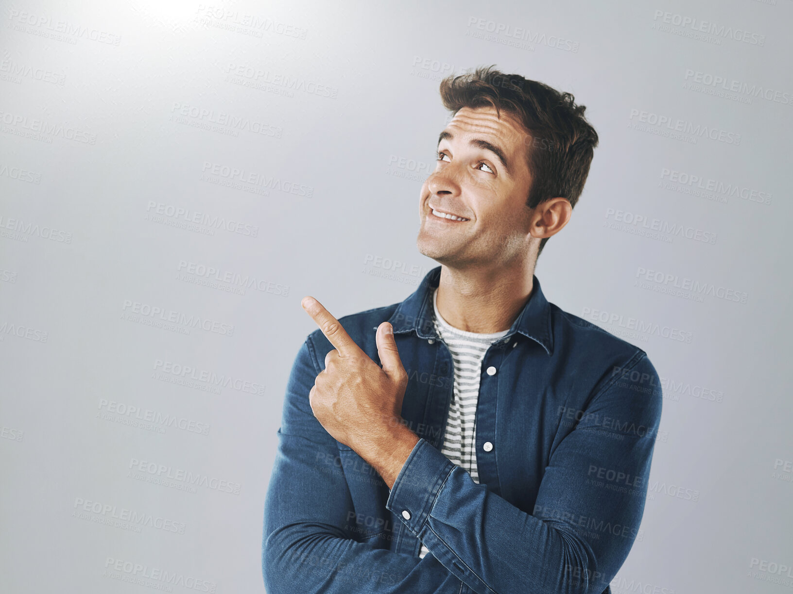 Buy stock photo Man, studio and pointing at mockup for choice, opinion and idea on gray background. Male designer, decision and hand gesture for product with smile, guide and information for industry on copy space