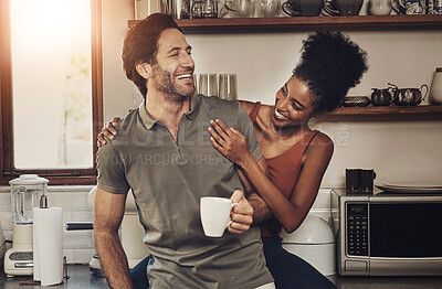 Buy stock photo Interracial couple, together and happiness with coffee in kitchen for wellness, morning routine or bonding in home. Man, woman and smile in house with tea for health, relax with partner or care