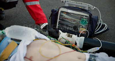 Buy stock photo Accident, paramedic and chest with defibrillator for help, emergency and healthcare on road. First responder, medic and male victim with support, injury and life saving on tarmac with protection