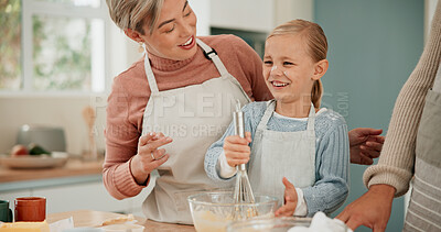 Buy stock photo Happy family, child and baking with bowl for mixing ingredients, whisking or hospitality together in kitchen at home. Mother and father teaching young baker, daughter or little girl for dessert skill