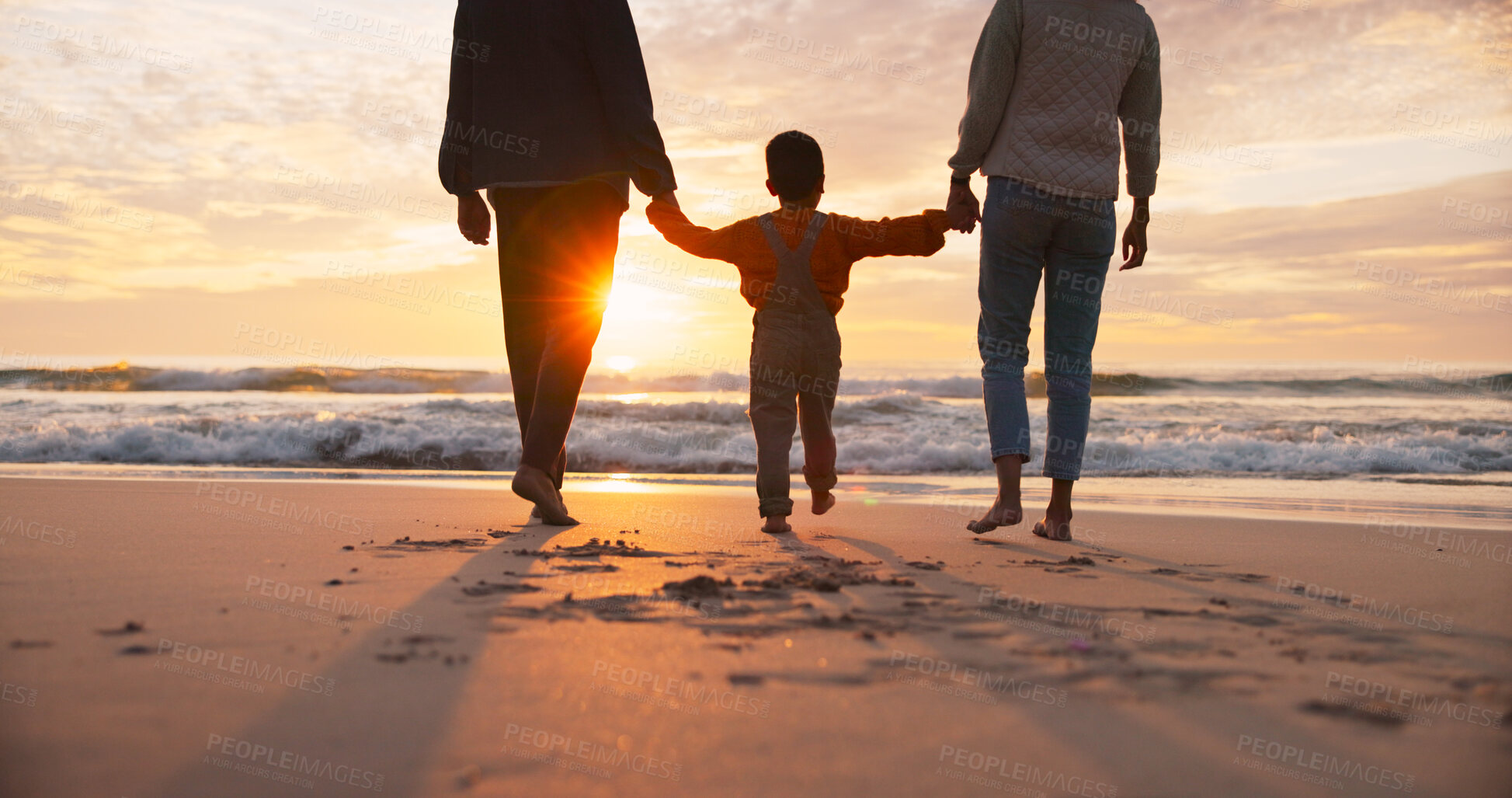 Buy stock photo Family, back and holding hands at beach in summer for relax, travel and vacation as silhouette. Parents, children and walking at ocean with solidarity for holiday, trust and love together by sunset
