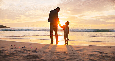 Buy stock photo Man, child and holding hands at beach in summer for relax, travel and vacation as silhouette on sand. Family, back and walking at ocean with solidarity for holiday, trust and love together by sunset
