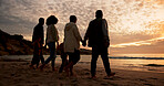 Family, sunset and holding hands at beach in summer for relax, travel and vacation as silhouette. Parents, children and back at ocean with solidarity for holiday, trust and love together by walking
