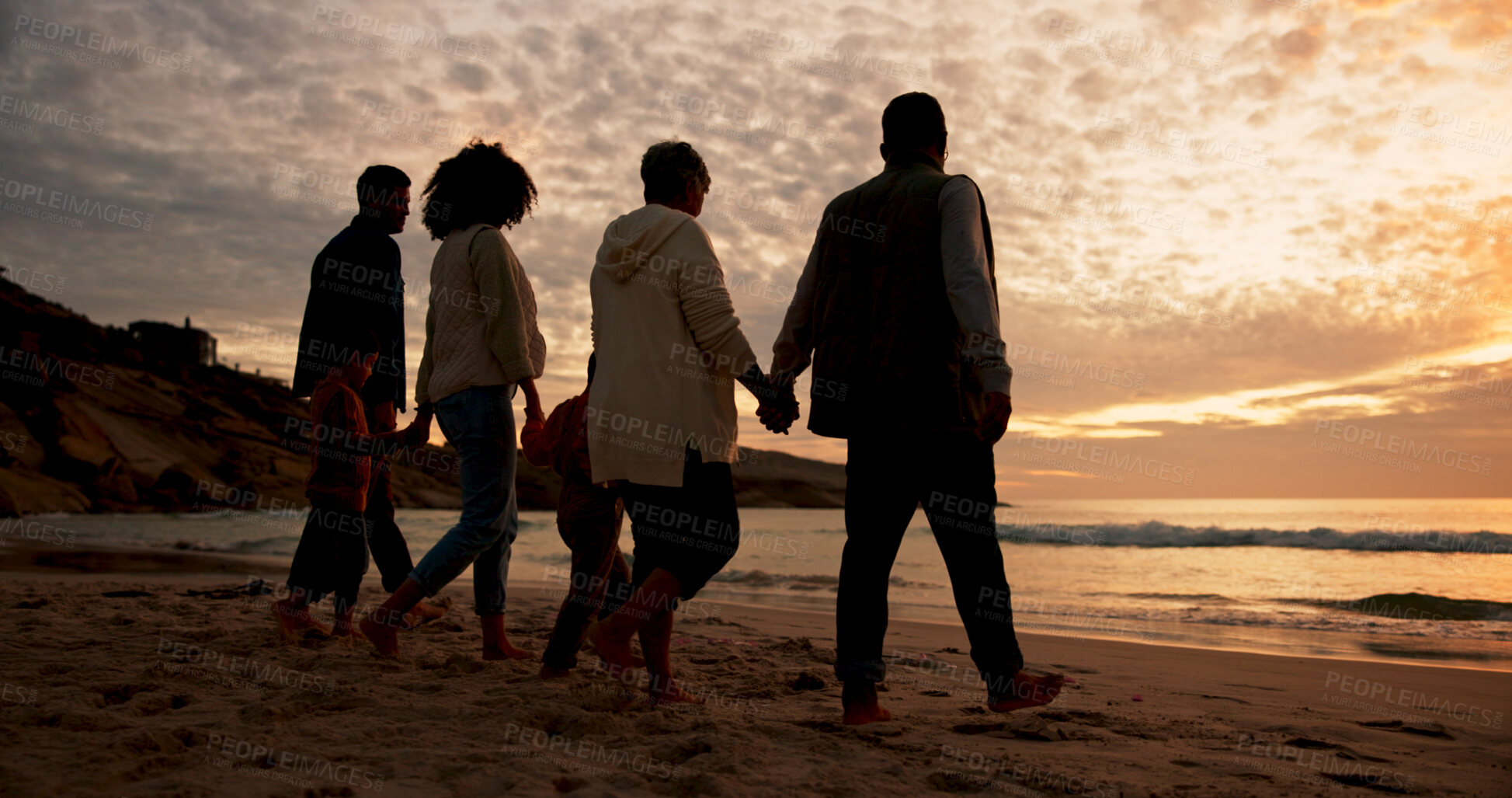 Buy stock photo Family, sunset and holding hands at beach in summer for relax, travel and vacation as silhouette. Parents, children and back at ocean with solidarity for holiday, trust and love together by walking
