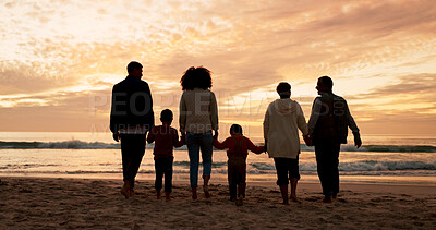 Buy stock photo Family, walking and holding hands at beach in summer for relax, travel and vacation as silhouette. Parents, children and back at ocean with solidarity for holiday, trust and love together by sunset