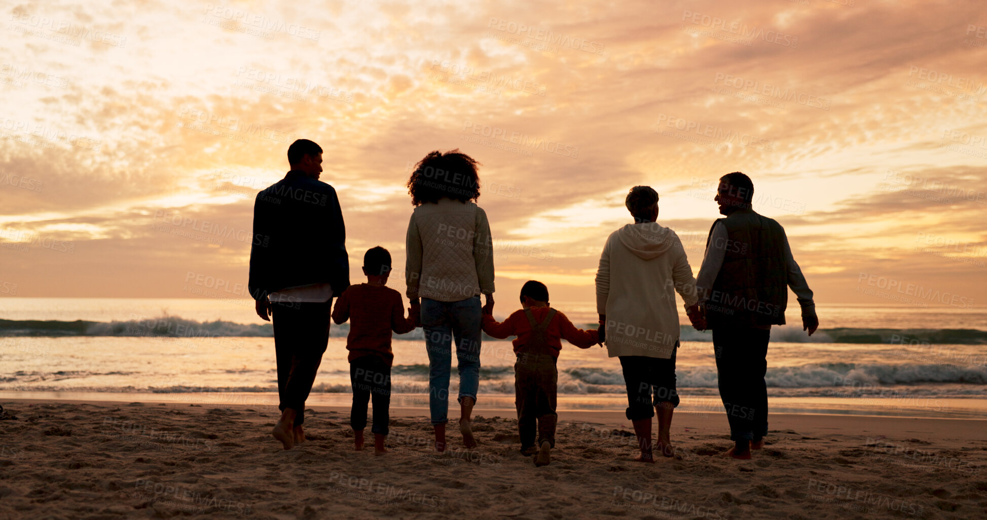 Buy stock photo Family, walking and holding hands at beach in summer for relax, travel and vacation as silhouette. Parents, children and back at ocean with solidarity for holiday, trust and love together by sunset