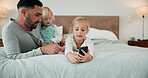 Bed, phone and father with girl children in home for bonding, communication or social media safety. App, mobile and streaming with man teaching sister kids how to be responsible online in bedroom