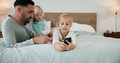 Buy stock photo Bed, phone and father with girl children in home for bonding, communication or social media safety. App, mobile and streaming with man teaching sister kids how to be responsible online in bedroom