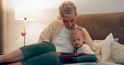 Buy stock photo Grandma, girl and reading book in bed at night, literature and storytelling at bedtime. Home, grandparent and child learning together for love, language and support toddler for fiction fairytale