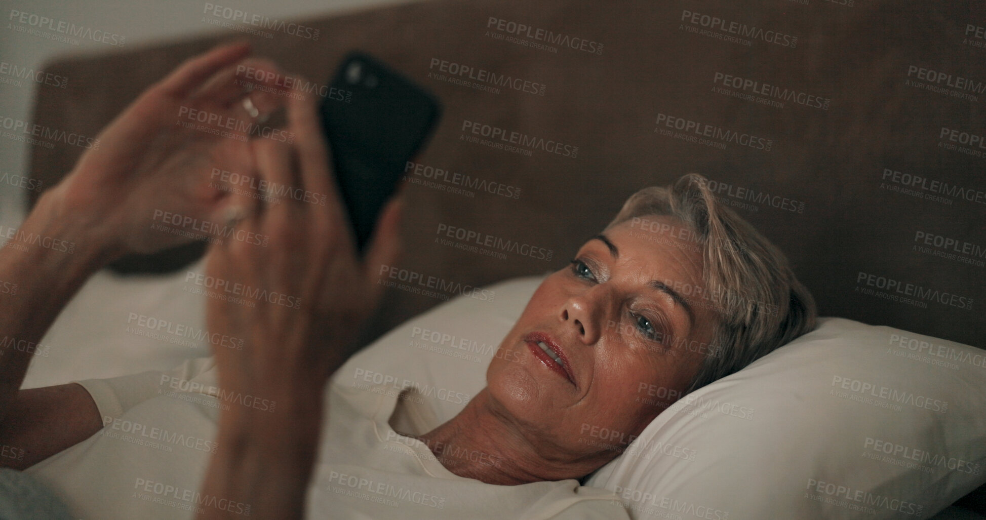 Buy stock photo Reading, bed and mature woman with phone for online blog on insomnia, sleep apnea or relaxing. Communication, night and senior female person networking with email on smartphone in bedroom at home.