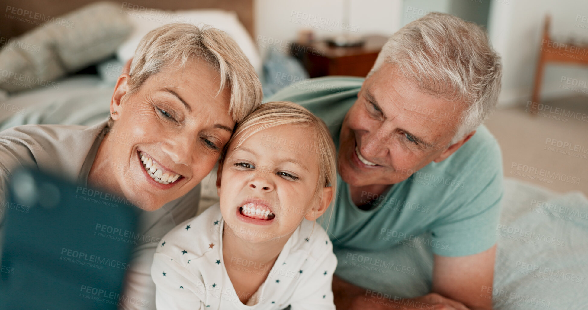 Buy stock photo Funny face, smile and selfie of kid with grandparents for happy memory, love or family bonding. Grandma, grandfather and picture of girl child for connection, care or photo together in home bedroom