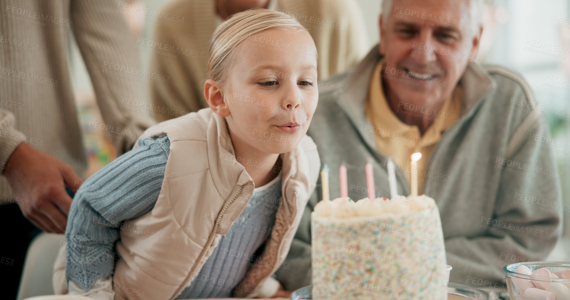 Buy stock photo Girl, family and blowing cake for birthday celebration with excitement, love and support for fun. People, happy and cheerful for party or event with child development, growth and care at home